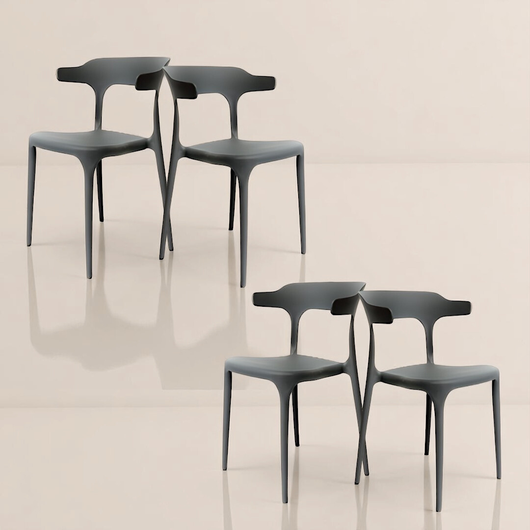  Four dark gray sculpted chairs with artistic backrests, arranged in a square formation on a glossy floor.