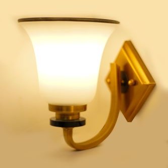 A metal wall sconce with a frosted glass shade, equipped with a led lamp e27 emitting warm illumination against a beige background.