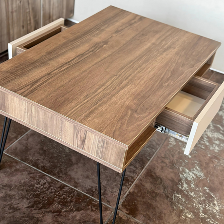 Front view of the center table highlighting a clean-lined walnut wood top, three open compartments, and a central white drawer.