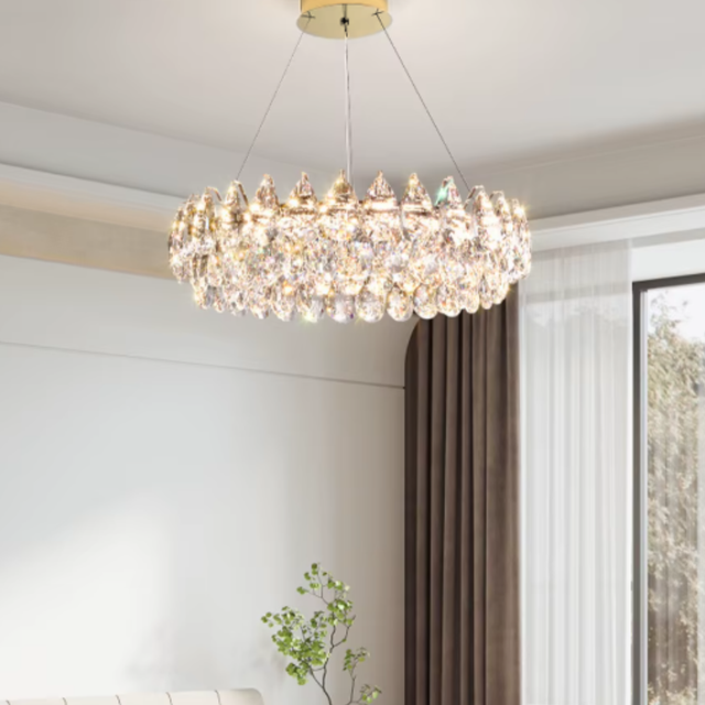 Chandelier hanging in a room with a window and plant