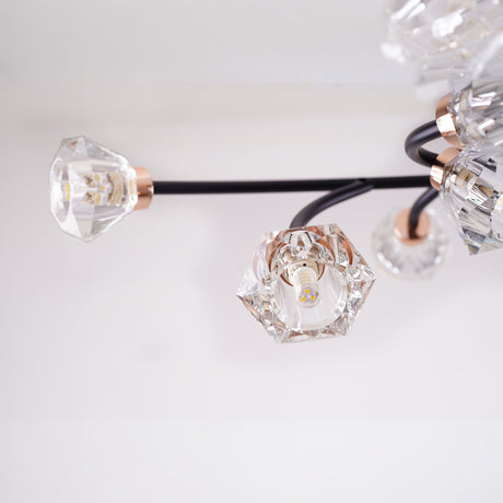  A close-up view of a modern light fixture with black curved arms and diamond-shaped glass bulbs.