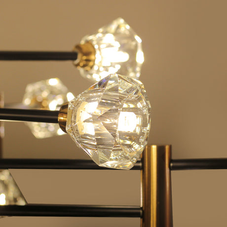 A close-up of a crystal-shaped bulb on a modern chandelier with gold and black accents.