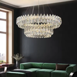 Luxurious chandelier hanging above a green sofa in a modern living room.