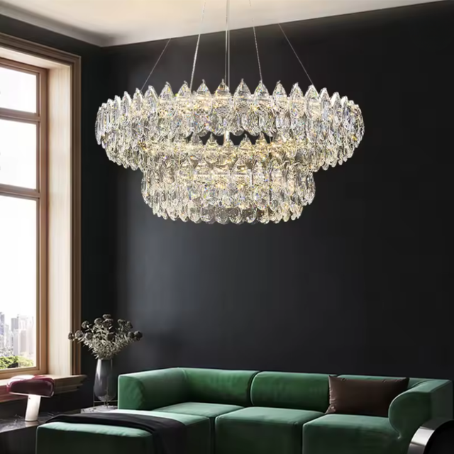 Luxurious chandelier hanging above a green sofa in a modern living room.