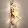 A modern gold and crystal wall light with a stacked diamond design, creating a luxurious ambiance.