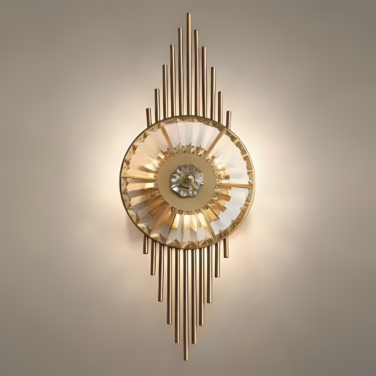 A luxurious gold and crystal wall sconce with vertical metal rods extending above and below a central circular light fixture, emitting a soft glow.