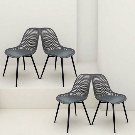 four dark grey mesh-style chairs with black legs, positioned in a mirrored pose on staggered white platforms.