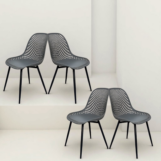 four dark grey mesh-style chairs with black legs, positioned in a mirrored pose on staggered white platforms.