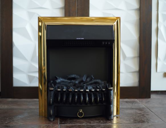 A black electric fireplace with a golden frame, featuring artificial logs inside but no active flame.