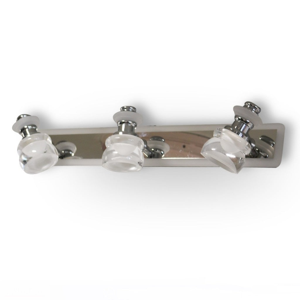 A sleek and contemporary triple-led bulb chrome wall light fixture with clear glass shades, mounted on a metallic base.