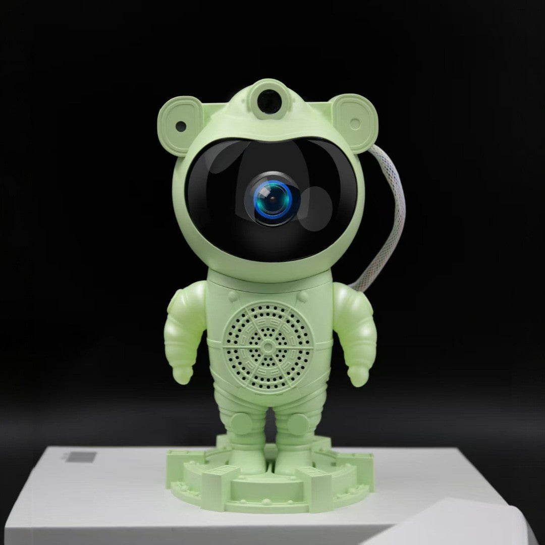 Green robot toy with a black screen on a white platform against a black background