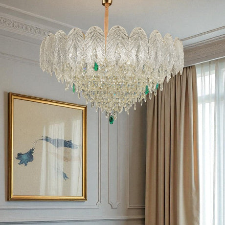 Luxurious living room with a chandelier, blue sofa, and framed artwork.
