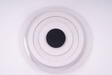  Circular flush mount ceiling light with a layered design of three concentric white rings surrounding a black center, emitting soft white light.