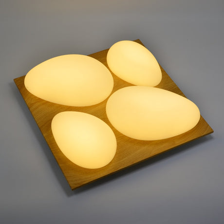 A square ceiling fixture with four rounded triangular lights arranged in a clover shape, 