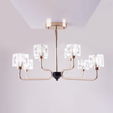 A modern chandelier with a rose gold metal frame and six cubic glass light covers.