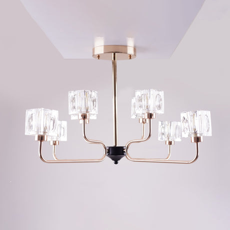 A modern chandelier with a rose gold metal frame and six cubic glass light covers.