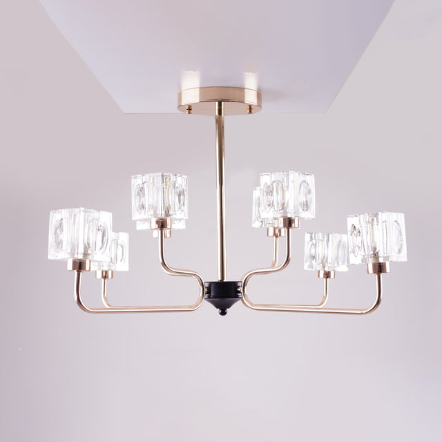 A modern chandelier with a rose gold metal frame and six cubic glass light covers.