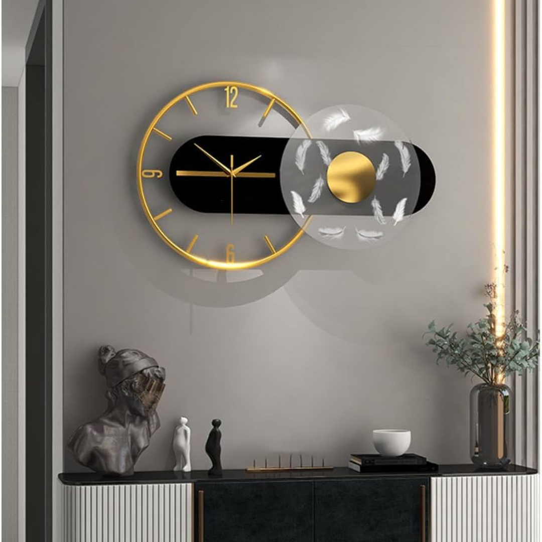 Modern wall clock with gold and black design on a gray wall.