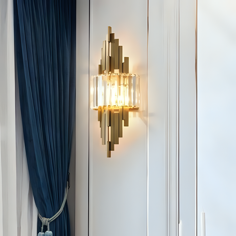 modern gold and crystal sconce mounted beside a blue curtain in an elegant interior setting.