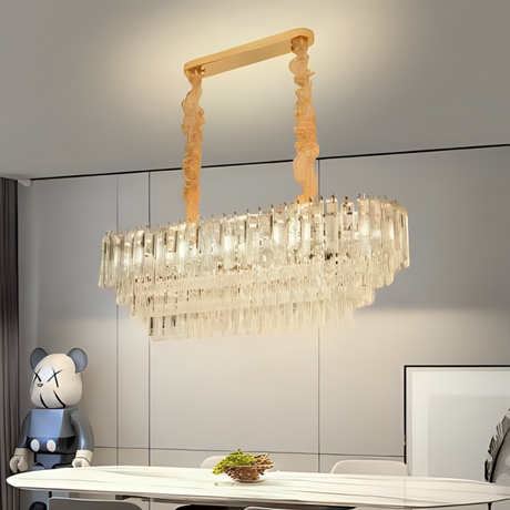 A luxurious crystal chandelier hanging above a dining table with wooden and metal accents.