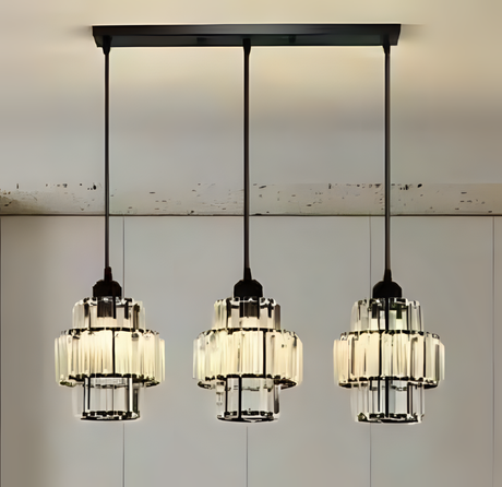 Three industrial-style pendant lights with black metal frames and glass shades, hanging from a black rectangular ceiling mount.
