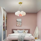A cloud-inspired pendant light fixture with multiple frosted white globes, creating a soft and airy look.
