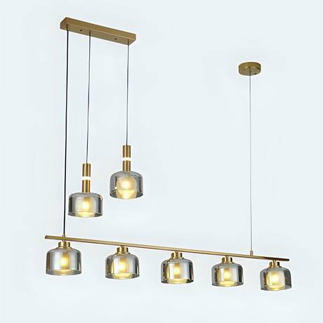 A linear arrangement of metal and glass pendant lights with exposed bulbs, suspended from a gold ceiling mount.