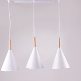 Three identical white cone-shaped pendant lights hanging from a white ceiling mount.
