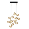 A modern gold chandelier with spherical glass bulbs arranged in a curved design, suspended from a black rectangular ceiling mount.
