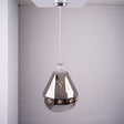 A geometric, faceted metal pendant light with reflective surfaces and decorative patterns, hanging from the ceiling.