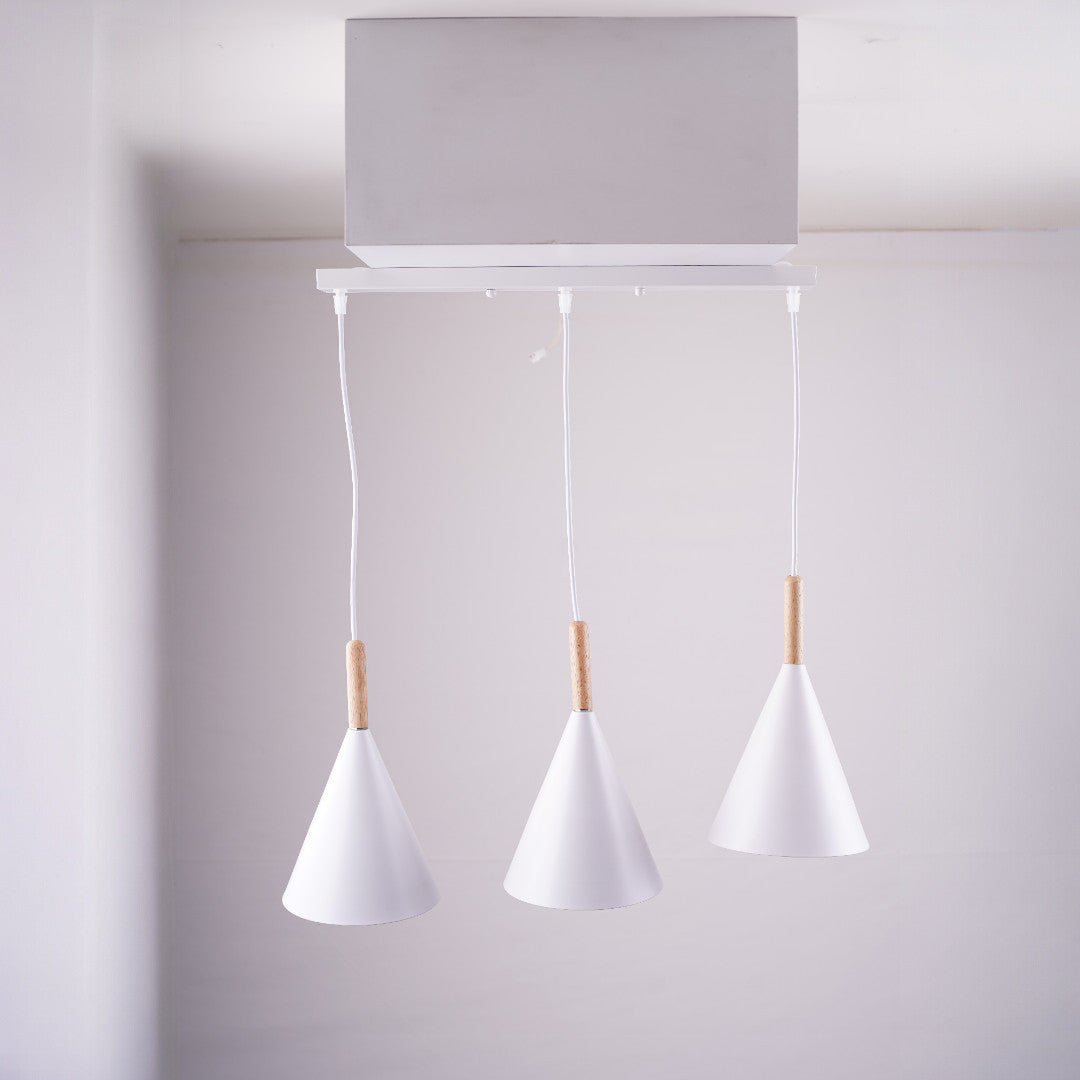 A three white cone-shaped pendant lights, emphasizing the ceiling mount.
