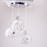 The floral-inspired pendant lights in daylight, showing their intricate wireframe design.
