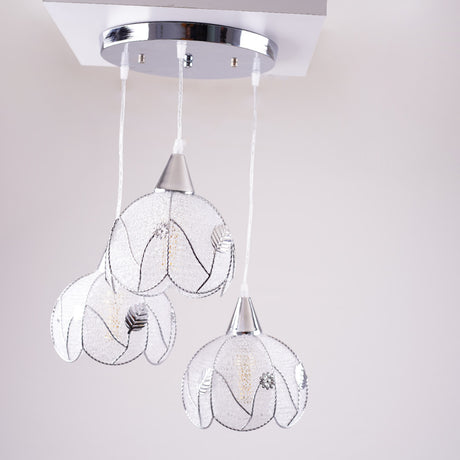 The floral-inspired pendant lights in daylight, showing their intricate wireframe design.
