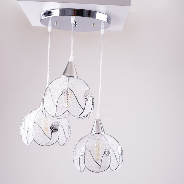 The floral-inspired pendant lights in daylight, showing their intricate wireframe design.
