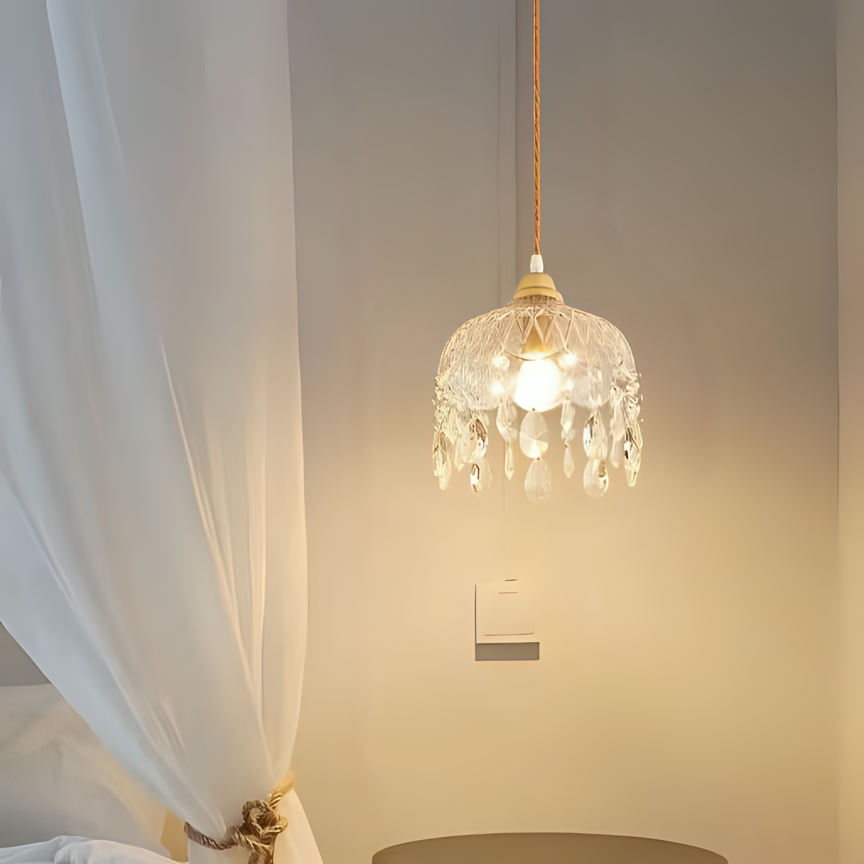 A vintage-style crystal pendant light with delicate hanging beads, emitting a warm glow.