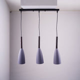 A trio of grey pendant lights suspended from a black rectangular ceiling mount.
