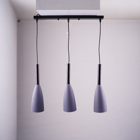 A trio of grey pendant lights suspended from a black rectangular ceiling mount.
