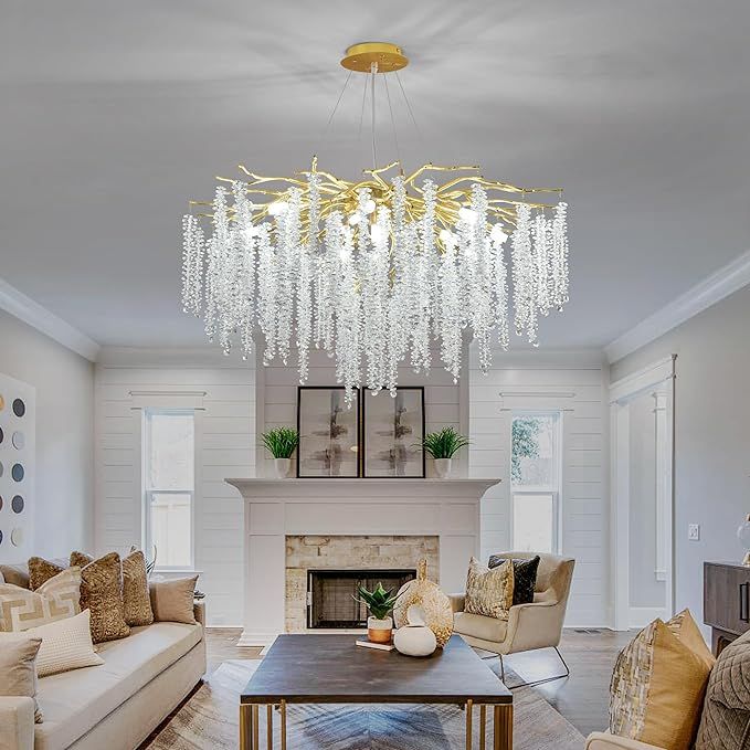 Large gold chandelier with cascading crystal strands resembling willow leaves, installed in a cozy, elegant living room.


