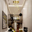 Helical chandelier with cascading crystal balls and soft LED lights in a modern two-story apartment.