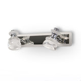 A sleek and contemporary double-led bulb chrome wall light fixture with clear glass shades, mounted on a metallic base.