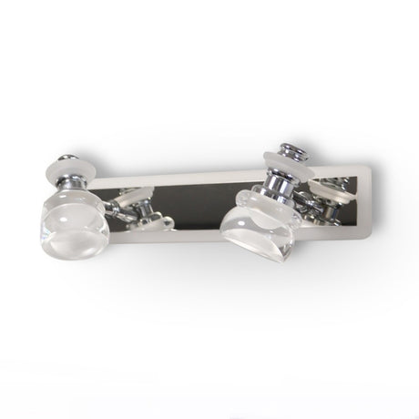 A sleek and contemporary double-led bulb chrome wall light fixture with clear glass shades, mounted on a metallic base.