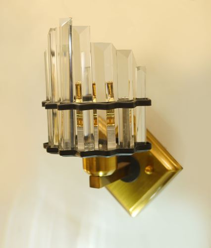 This close-up shot highlights the layered design of the transparent crystal rods, which refract the LED light, producing a warm and dazzling illumination.