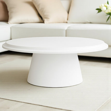 White coffee table in a living room setting with a sofa and decorative pillows.