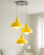 Three yellow pendant lights hanging in a room with a neutral color scheme.